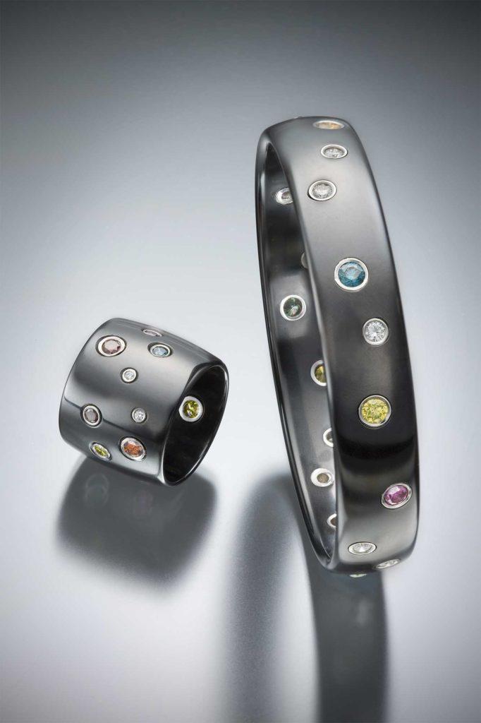 Gem ceramic ring and bracelet set with pink diamonds, blue diamonds, yellow diamonds, green diamonds and fine white diamonds in 18kt gold bezel settings.